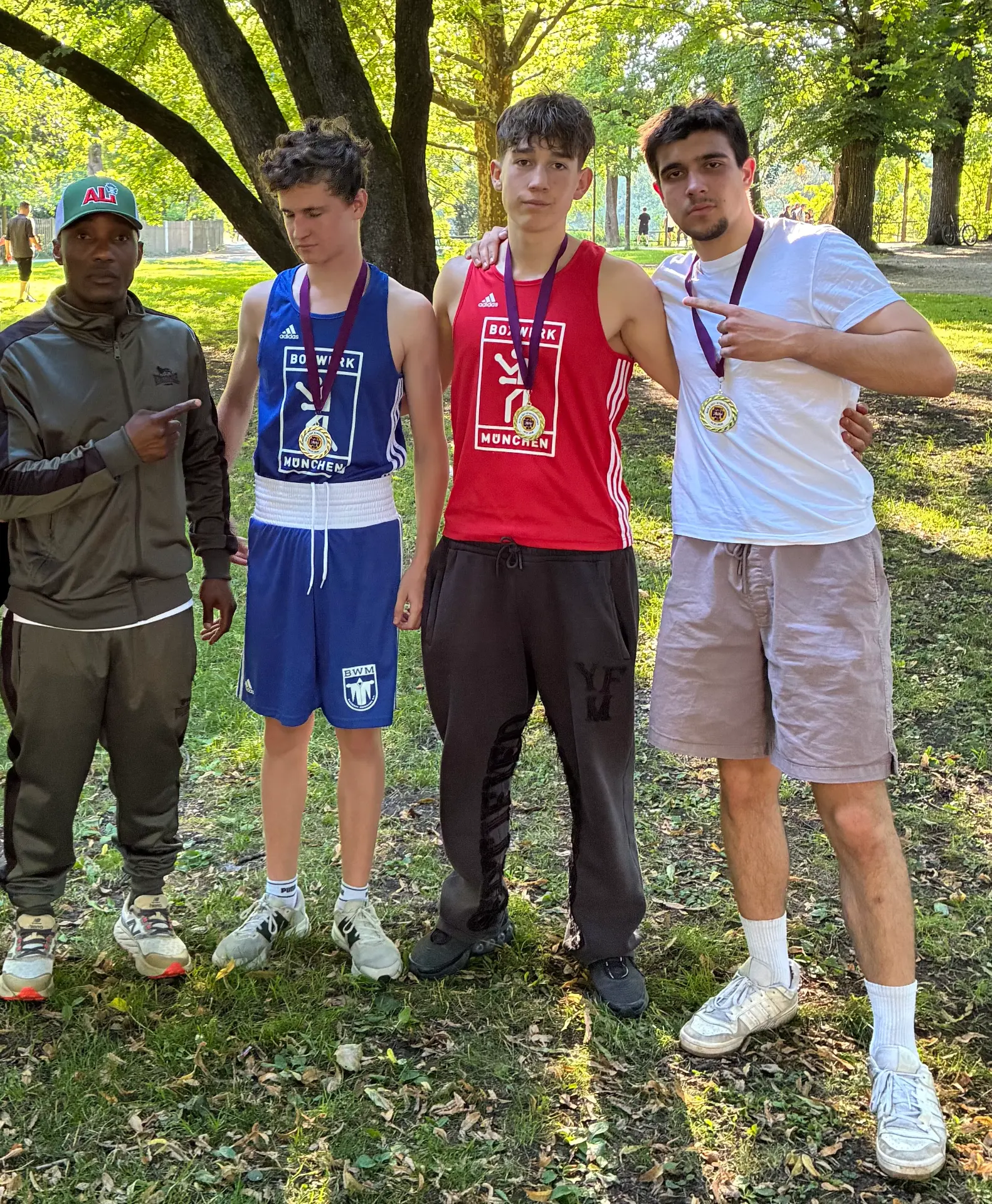 Coach Walu with three young Boxwerk Munich boxers wearing their medals